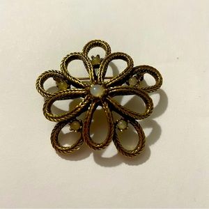 Vintage gold toned braided pin/brooch with opal looking stones.